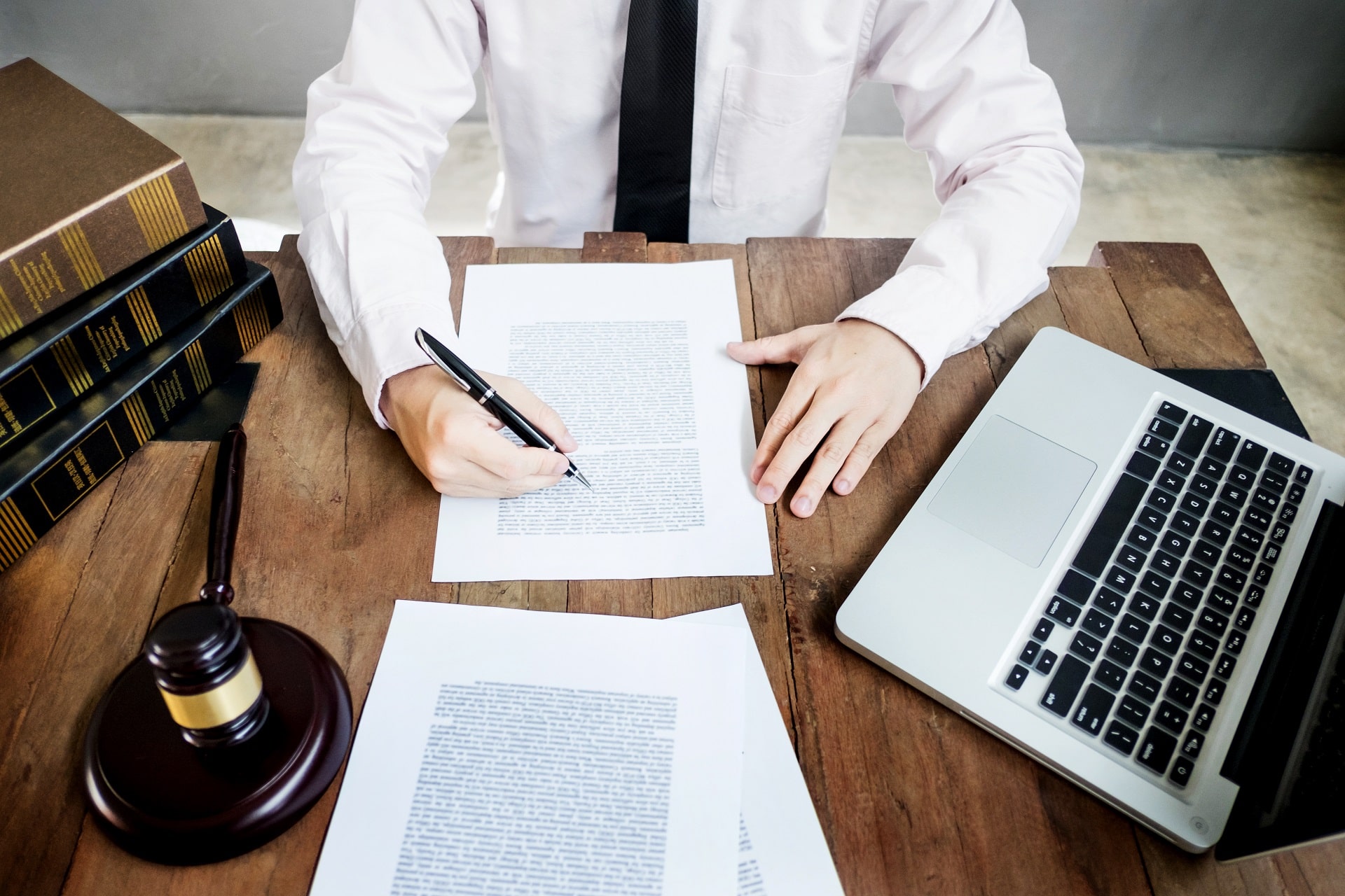 Person at desk with documents, laptop, and gavel | Social Security Attorney | Drew L Johnson, P.C.