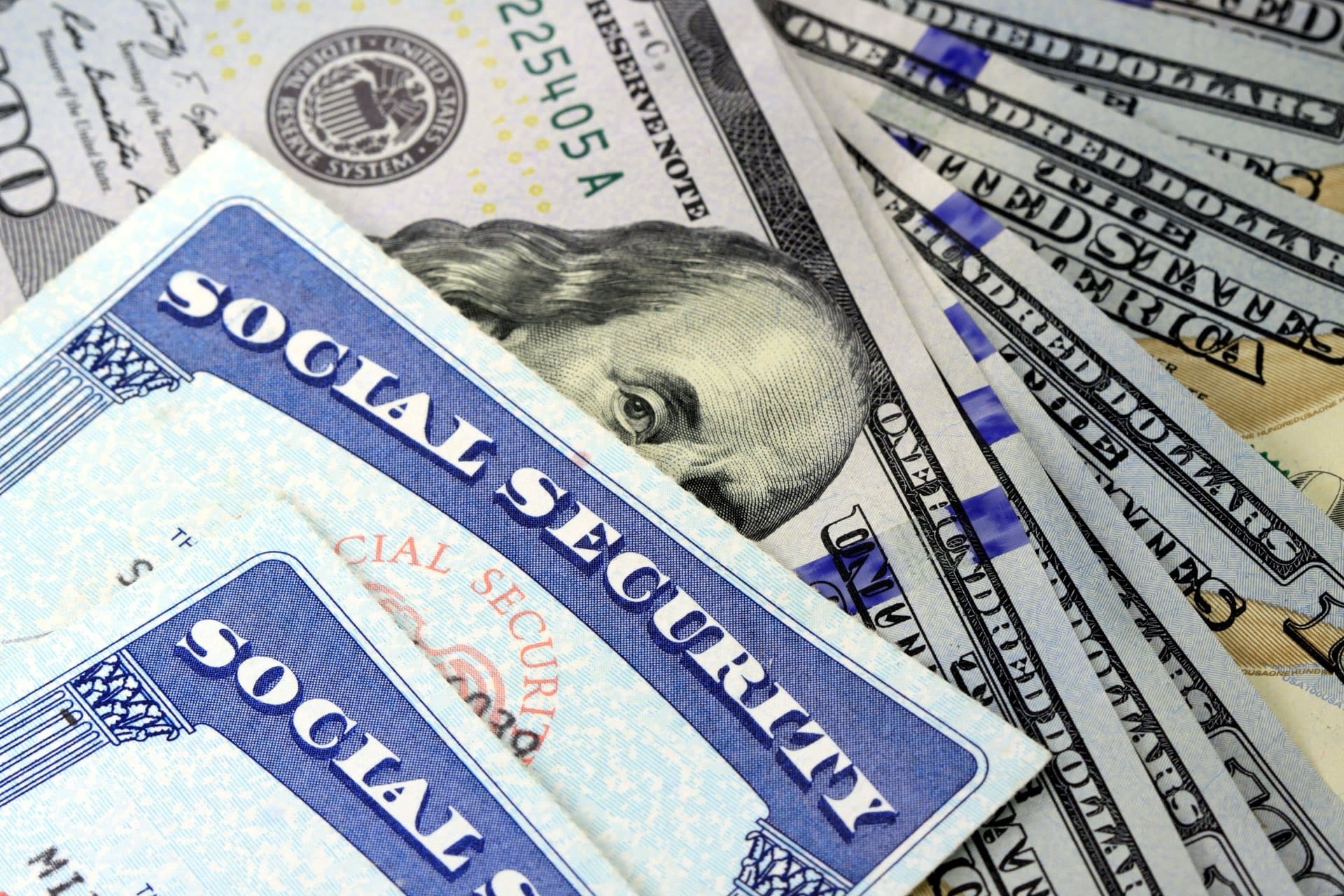 Social security cards on top of money